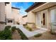 Private courtyard with fireplace and lush landscaping at 2475 Grassy Spring Pl, Las Vegas, NV 89135