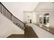 Elegant entryway with dark wood staircase and granite flooring at 2475 Grassy Spring Pl, Las Vegas, NV 89135