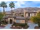 Two-story house with tile roof, stucco siding, and a three-car garage at 2475 Grassy Spring Pl, Las Vegas, NV 89135