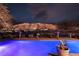 Stunning pool with mountain views at night at 2475 Grassy Spring Pl, Las Vegas, NV 89135