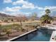 Relaxing pool and spa area with mountain backdrop at 2475 Grassy Spring Pl, Las Vegas, NV 89135