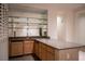 Wet bar with granite countertop and glass shelving at 2475 Grassy Spring Pl, Las Vegas, NV 89135