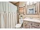 Bathroom featuring a weathered vanity and a farmhouse-style shower curtain at 2540 Eagle St, Las Vegas, NV 89142