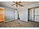 This bedroom features wood-look floors, a ceiling fan with lights, and an open closet at 2540 Eagle St, Las Vegas, NV 89142