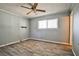 This bedroom features wood-look floors, a window, and a ceiling fan with lights at 2540 Eagle St, Las Vegas, NV 89142