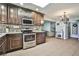 Kitchen with stainless steel appliances, dark cabinets, and a decorative tile backsplash at 2540 Eagle St, Las Vegas, NV 89142