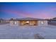 House's back elevation at dusk, featuring a covered patio at 2669 Pioneer Estates Ct, Las Vegas, NV 89117