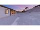 View of a home's backyard at dusk, showing a sloped lot at 2669 Pioneer Estates Ct, Las Vegas, NV 89117