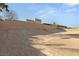 Empty lot with gravel and a block wall in the background at 2669 Pioneer Estates Ct, Las Vegas, NV 89117