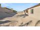 Large, unlandscaped backyard with gravel and a block wall at 2669 Pioneer Estates Ct, Las Vegas, NV 89117