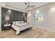 Bright bedroom with wood-look floors and gray accent wall at 2669 Pioneer Estates Ct, Las Vegas, NV 89117