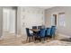 Elegant dining room featuring a beautiful built-in niche and stylish blue velvet chairs at 2669 Pioneer Estates Ct, Las Vegas, NV 89117