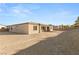 A view of the house exterior showing the backyard and covered patio under a clear blue sky at 2669 Pioneer Estates Ct, Las Vegas, NV 89117