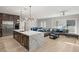 Modern kitchen with marble island and stainless steel appliances, open to Gathering room at 2669 Pioneer Estates Ct, Las Vegas, NV 89117