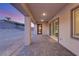 Inviting covered patio with gray pavers, perfect for outdoor relaxation and entertaining during twilight at 2669 Pioneer Estates Ct, Las Vegas, NV 89117