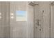 Modern shower with multiple shower heads and glass enclosure at 2669 Pioneer Estates Ct, Las Vegas, NV 89117