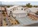 Two-story house with three-car garage and landscaped yard, offering mountain views at 2682 Korea Ct, Henderson, NV 89052