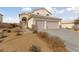 Two-story house with three-car garage and desert landscaping at 2682 Korea Ct, Henderson, NV 89052