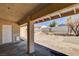 Spacious backyard with covered patio, storage shed, and gravel landscaping at 303 Glasgow St, Henderson, NV 89015