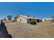 Large gravel backyard with partial view of house and shed at 303 Glasgow St, Henderson, NV 89015