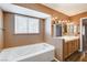 Bathroom with soaking tub, double vanity, and tile floor at 303 Glasgow St, Henderson, NV 89015