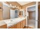 Double sink bathroom with light wood cabinets at 303 Glasgow St, Henderson, NV 89015