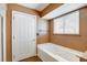 Bathroom with soaking tub, tiled surround and window at 303 Glasgow St, Henderson, NV 89015