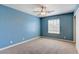 Blue-walled bedroom with ceiling fan and window at 303 Glasgow St, Henderson, NV 89015