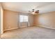 Spacious bedroom with ceiling fan and carpet flooring at 303 Glasgow St, Henderson, NV 89015