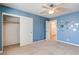 Spacious bedroom with ceiling fan and mirrored wall at 303 Glasgow St, Henderson, NV 89015