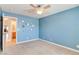 Blue bedroom with ceiling fan and access to bathroom at 303 Glasgow St, Henderson, NV 89015