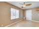 Spacious dining area with large window, wood flooring, and ceiling fan at 303 Glasgow St, Henderson, NV 89015