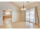 Spacious dining room with hardwood floors and sliding glass doors to backyard at 303 Glasgow St, Henderson, NV 89015