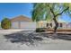 Single-story house with a three-car garage and mature landscaping at 303 Glasgow St, Henderson, NV 89015