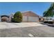 View of the home's exterior, showcasing a three-car garage and driveway at 303 Glasgow St, Henderson, NV 89015