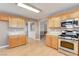 Kitchen with oak cabinets, stainless steel appliances, and tile countertops at 303 Glasgow St, Henderson, NV 89015