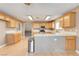 Bright kitchen features light wood cabinets, stainless steel appliances, and a breakfast bar at 303 Glasgow St, Henderson, NV 89015