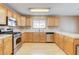 Kitchen boasts stainless steel appliances and oak cabinets at 303 Glasgow St, Henderson, NV 89015