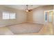 Spacious living room with carpeted floors and ceiling fan at 303 Glasgow St, Henderson, NV 89015