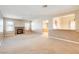 Open living room with neutral carpet and views into kitchen area at 303 Glasgow St, Henderson, NV 89015