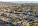 Aerial view of residential neighborhood; showcasing a large house with a pool and a spacious backyard at 328 Hedgehope Dr, Las Vegas, NV 89183