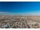 Aerial view of expansive cityscape; featuring distant mountains and clear blue skies at 328 Hedgehope Dr, Las Vegas, NV 89183