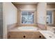 Relaxing bathroom featuring a large soaking tub and a window with a view at 328 Hedgehope Dr, Las Vegas, NV 89183