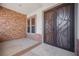 Front entry with stone accent wall and double doors at 328 Hedgehope Dr, Las Vegas, NV 89183