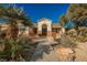 House exterior with a walkway, palm trees, and drought-tolerant landscaping at 328 Hedgehope Dr, Las Vegas, NV 89183