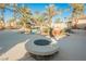 Round fire pit in a landscaped backyard at 328 Hedgehope Dr, Las Vegas, NV 89183