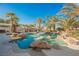 Inviting backyard oasis with a large pool, spa, and rock waterfall feature at 328 Hedgehope Dr, Las Vegas, NV 89183