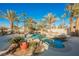 Backyard pool and spa with palm trees and rock features at 328 Hedgehope Dr, Las Vegas, NV 89183