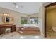 Spa-like bathroom featuring a large corner jacuzzi tub and a view at 3495 Pama Ln, Las Vegas, NV 89120