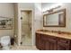 Bathroom with a walk-in shower, modern vanity, and marble accents at 3495 Pama Ln, Las Vegas, NV 89120